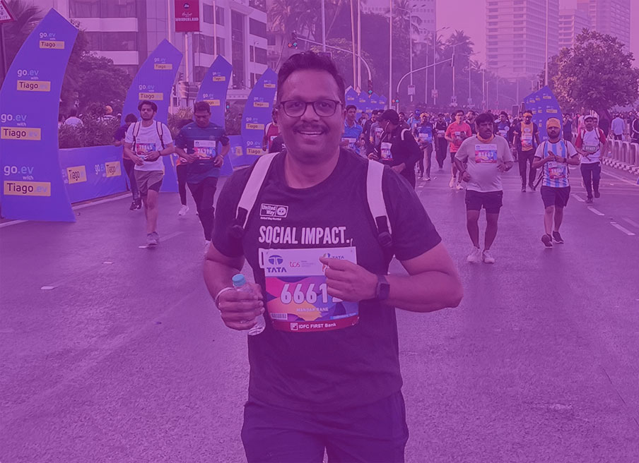 A runner in a t-shirt and backpack participating in a marathon